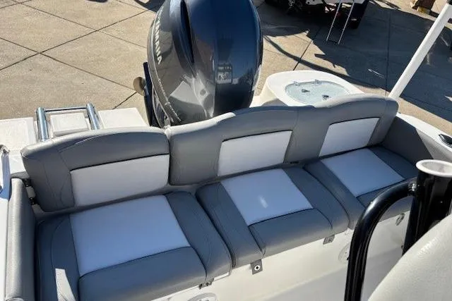 Slide: The Image of 2022 NauticStar 2102 Legacy boat with cushioned seating and outboard motor. - 2