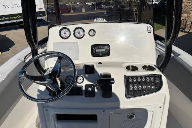 Slide: The Image of Center console of 2022 NauticStar 2102 Legacy boat with steering wheel and gauges. - 5
