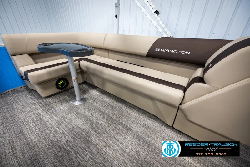 Slide: The Image of Interior of 2025 Bennington 20 SL with beige sofa and table. - 23