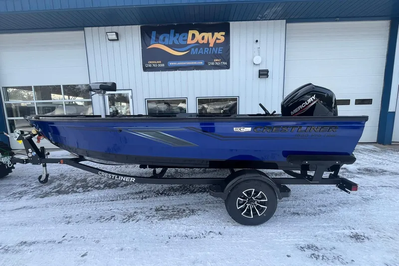 The Image of 2026 Crestliner 1650 Pro Tiller boat on trailer outside Lake Days Marine. - 1