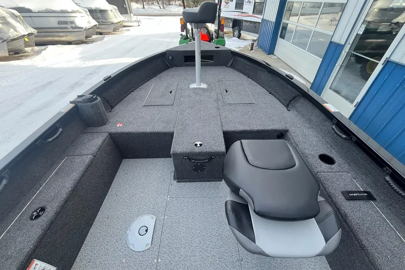 Slide: The Image of 2026 Crestliner 1650 Pro Tiller boat interior with seating and storage compartments. - 10