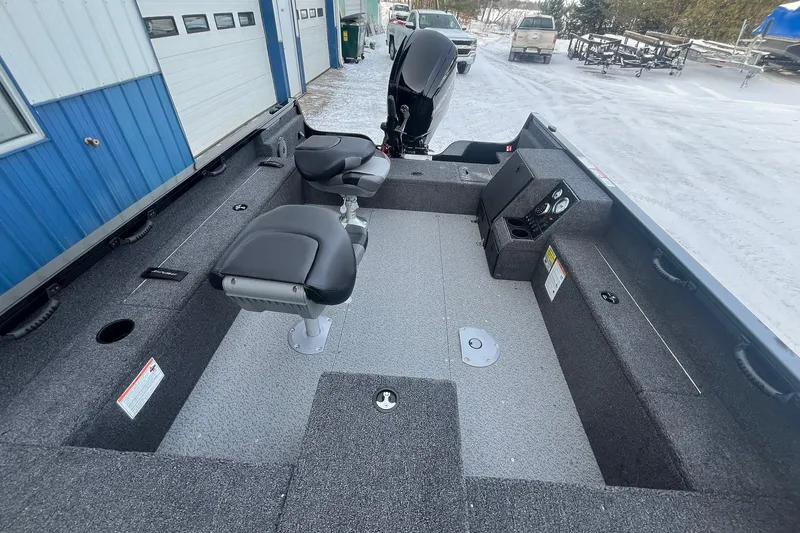 Slide: The Image of 2026 Crestliner 1650 Pro Tiller boat interior with seating and controls, parked in snowy area. - 15