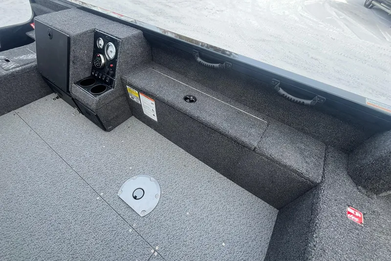 Slide: The Image of 2026 Crestliner 1650 Pro Tiller interior with control panel and storage compartments. - 17