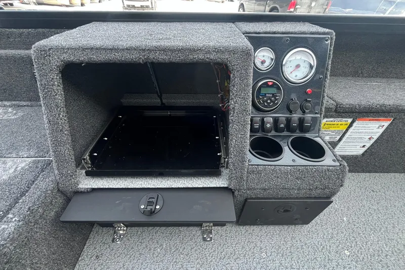 Slide: The Image of 2026 Crestliner 1650 Pro Tiller dashboard with gauges, controls, and storage compartment. - 20