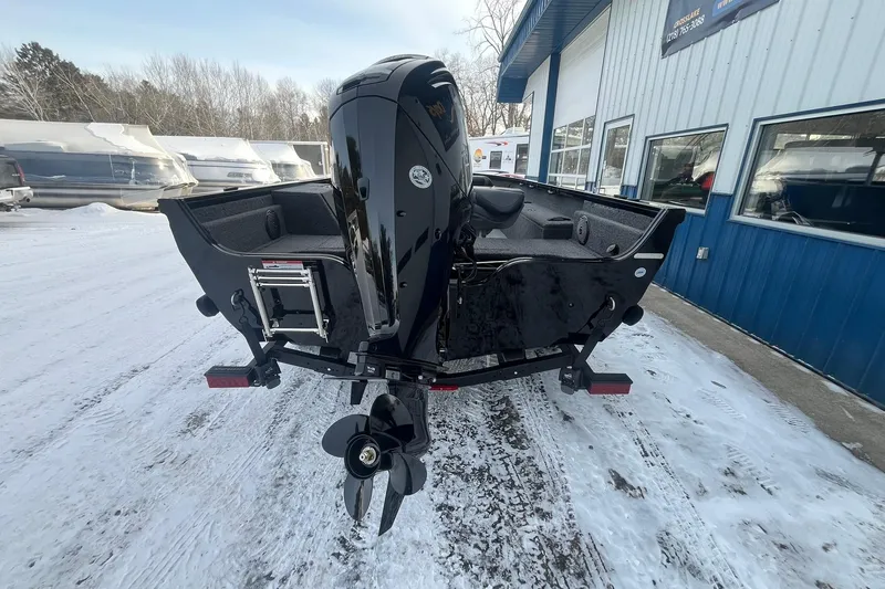 Slide: The Image of 2026 Crestliner 1650 Pro Tiller boat with outboard motor in snowy outdoor setting. - 3