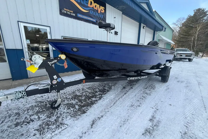 Slide: The Image of 2026 Crestliner 1650 Pro Tiller boat on trailer, parked outside dealership in snowy setting. - 7