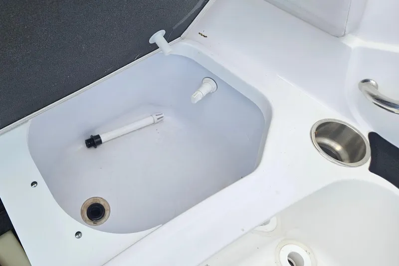 Slide: The Image of 2023 Hurricane SunDeck Sport 188 OB boat interior with sink and cup holder. - 14