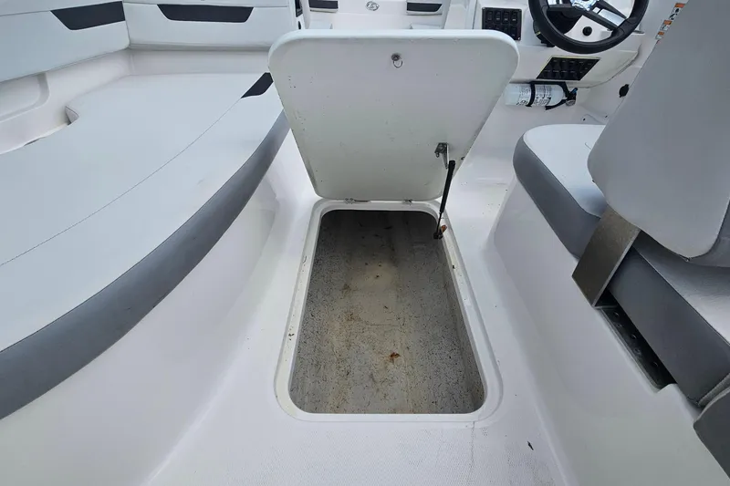 Slide: The Image of 2023 Hurricane SunDeck Sport 188 OB boat interior with open storage compartment. - 16