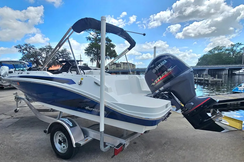 Slide: The Image of 2023 Hurricane SunDeck Sport 188 OB boat with Yamaha outboard motor at dockside. - 4