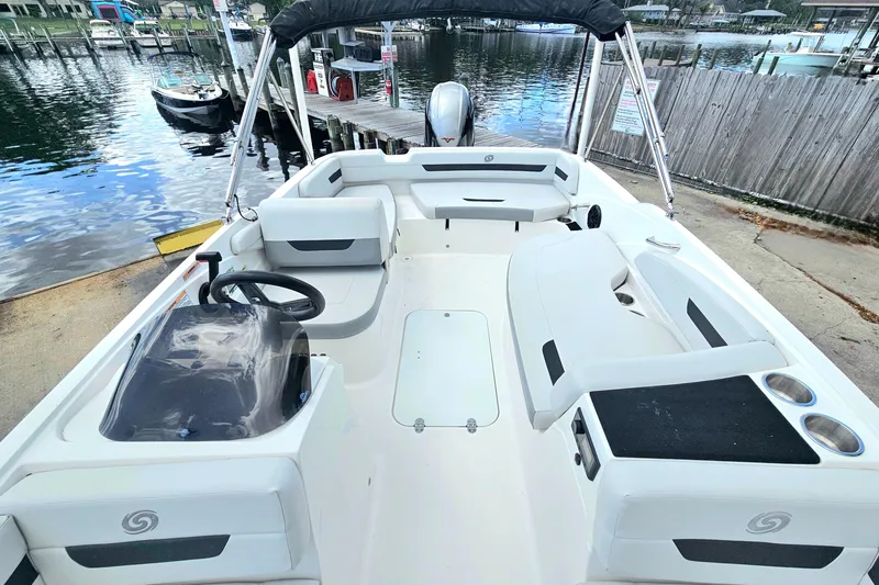 Slide: The Image of 2023 Hurricane SunDeck Sport 188 OB boat interior with seating and steering wheel. - 10