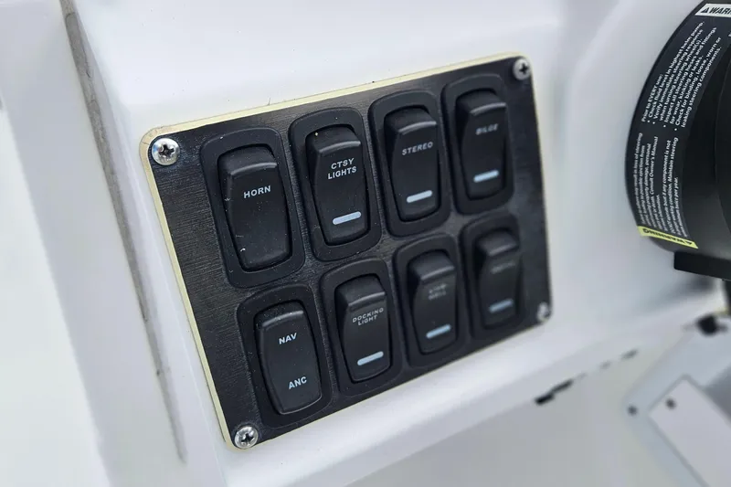 Slide: The Image of Control panel of 2023 Hurricane SunDeck Sport 188 OB boat with labeled switches. - 12