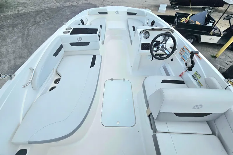 Slide: The Image of 2023 Hurricane SunDeck Sport 188 OB boat interior with seating and steering wheel. - 7