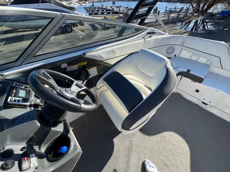 Slide: The Image of Interior of a 2014 Yamaha SX210 boat with steering wheel and seat. - 12