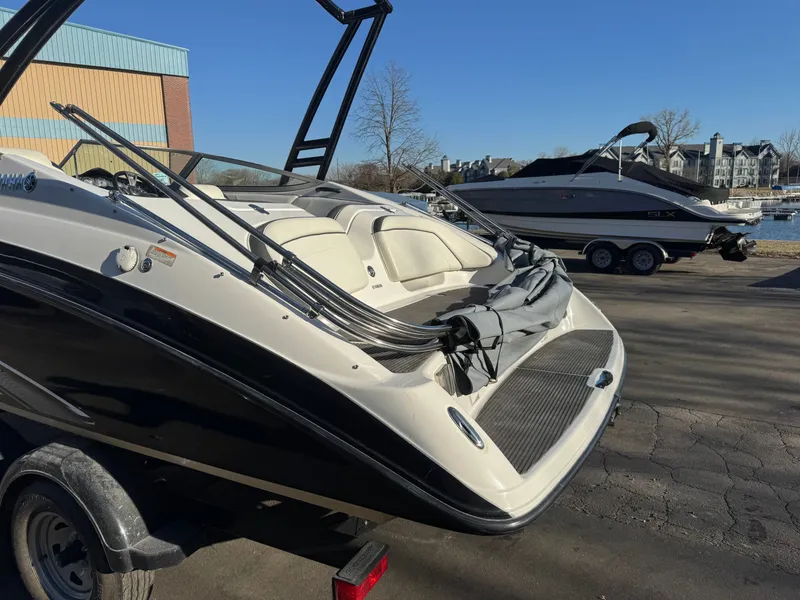 Slide: The Image of 2014 Yamaha SX210 boat on a trailer outdoors. - 21
