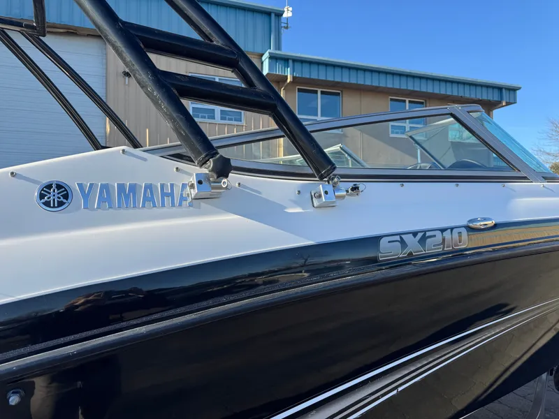 Slide: The Image of 2014 Yamaha SX210 boat, side view with logo and model name. - 26