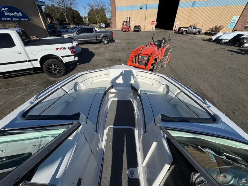 Slide: The Image of 2014 Yamaha SX210 boat outdoors with tractor in background. - 4