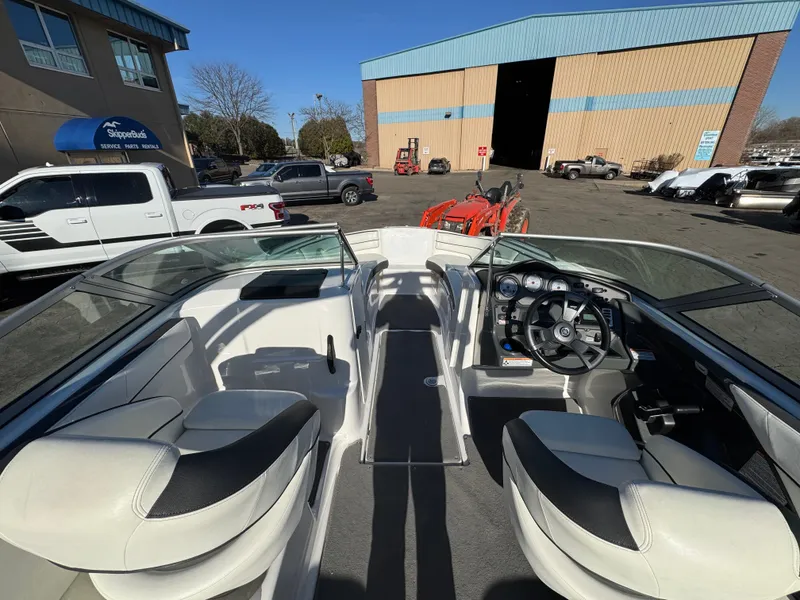 Slide: The Image of Interior view of a 2014 Yamaha SX210 boat in a parking lot. - 6