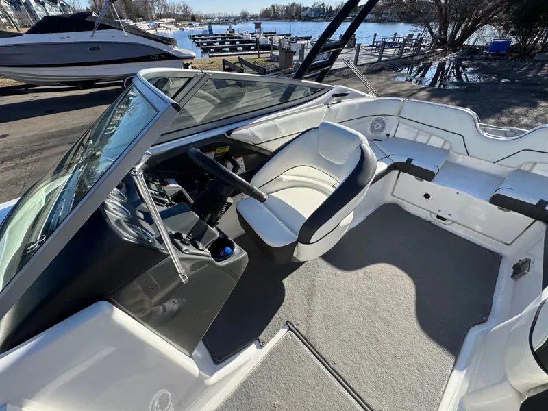 Slide: The Image of Interior of a 2014 Yamaha SX210 boat by the water. - 7