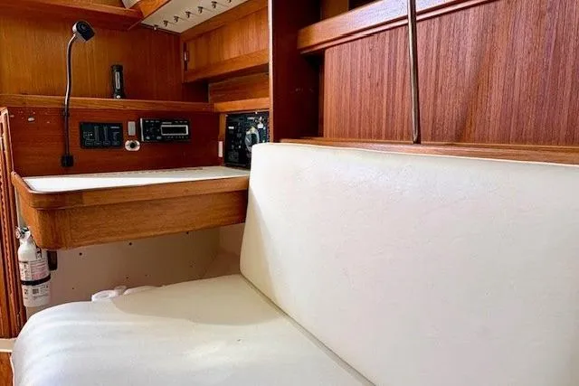 Slide: The Image of Interior of a 1992 Catalina 34 sailboat with wood paneling and navigation equipment. - 12