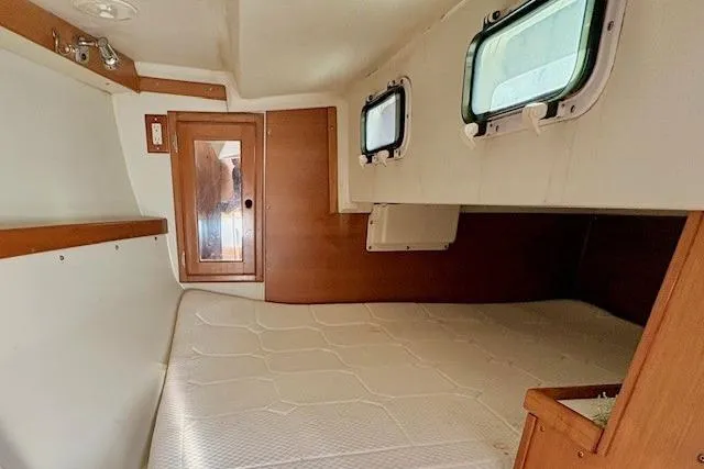 Slide: The Image of Interior cabin of a 1992 Catalina 34 sailboat with wooden accents and windows. - 16