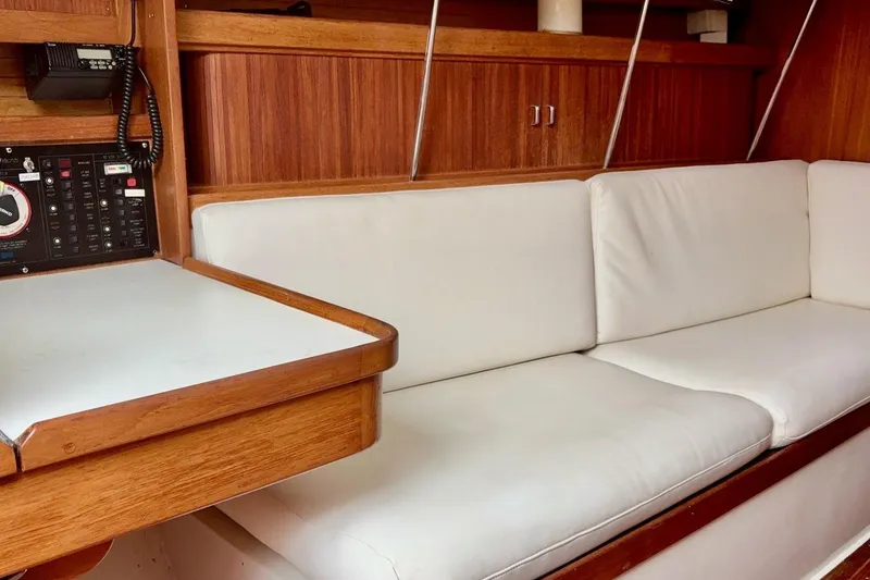 Slide: The Image of Interior of a 1992 Catalina 34 sailboat with white cushions and wooden cabinetry. - 18