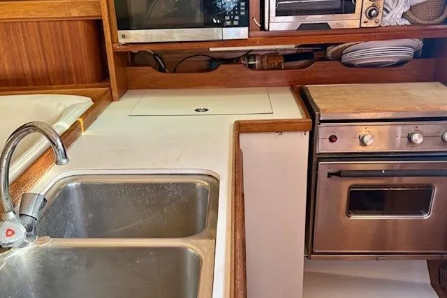Slide: The Image of Galley kitchen in 1992 Catalina 34 sailboat with sink, stove, and microwave. - 21