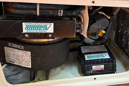 Slide: The Image of 1992 Catalina 34 engine compartment with marine air systems and components. - 23