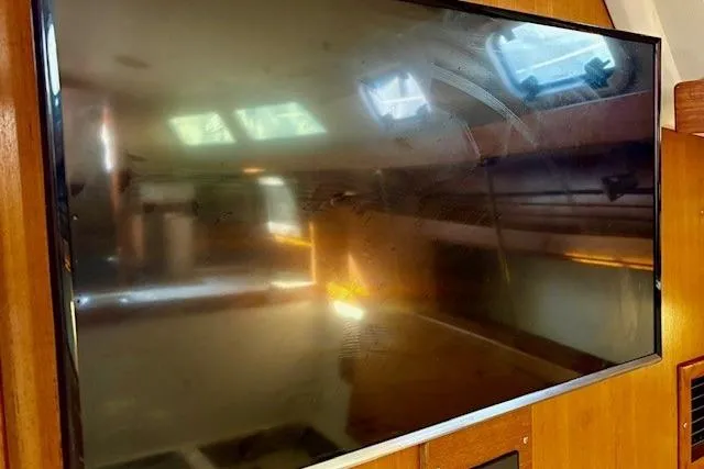 Slide: The Image of Flat-screen TV inside 1992 Catalina 34 yacht cabin, reflecting interior details. - 27