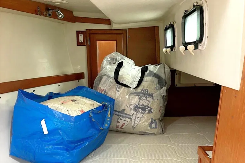 Slide: The Image of Interior cabin of a 1992 Catalina 34 sailboat with storage bags. - 28