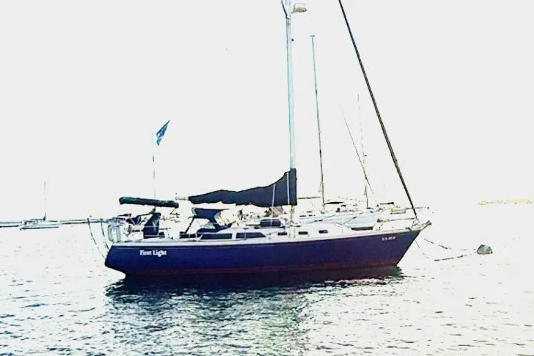 Slide: The Image of Sailboat Catalina 34, 1992 model, anchored on calm water. - 3