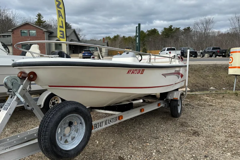 Slide: The Image of 1997 Boston Whaler Rage 15 boat on trailer, displayed outdoors for sale. - 3