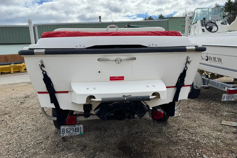 Slide: The Image of 1997 Boston Whaler Rage 15 boat rear view with trailer, parked outdoors. - 5