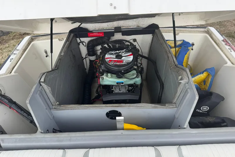 Slide: The Image of 1997 Boston Whaler Rage 15 engine compartment with visible motor and storage area. - 9