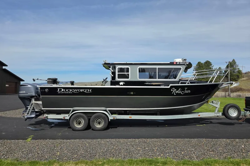 The Image of 2012 Duckworth 28 Offshore boat on trailer, parked outdoors under clear sky. - 0