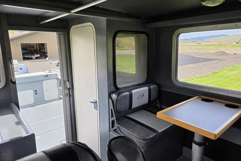 Slide: The Image of Interior of a 2012 Duckworth 28 Offshore boat with seating and table. - 14