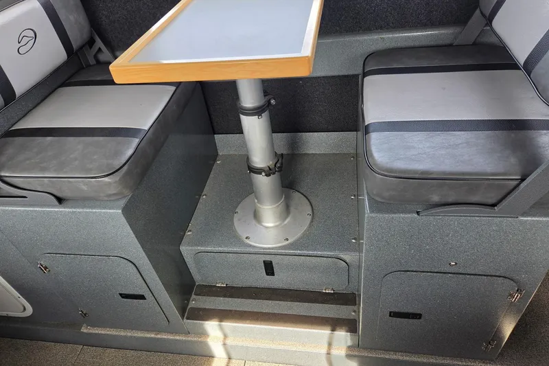 Slide: The Image of Interior seating area of a 2012 Duckworth 28 Offshore boat with table and storage. - 16