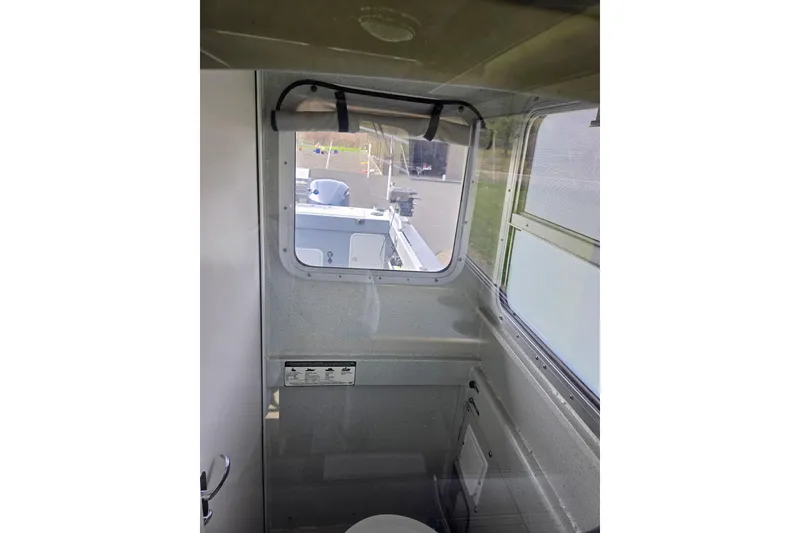 Slide: The Image of Interior view of a 2012 Duckworth 28 Offshore boat cabin with window. - 19