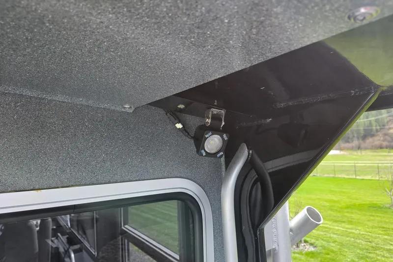 Slide: The Image of Interior view of a 2012 Duckworth 28 Offshore boat, showcasing a mounted light fixture. - 22