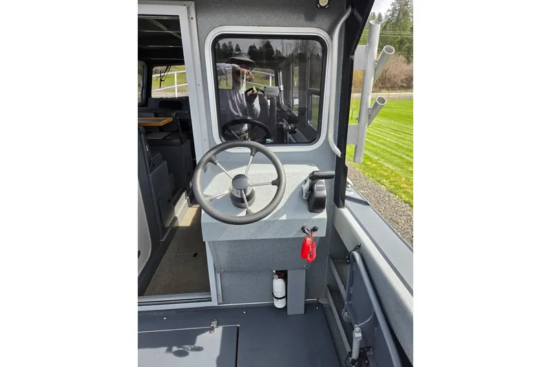 Slide: The Image of Interior view of 2012 Duckworth 28 Offshore boat cockpit with steering wheel. - 3