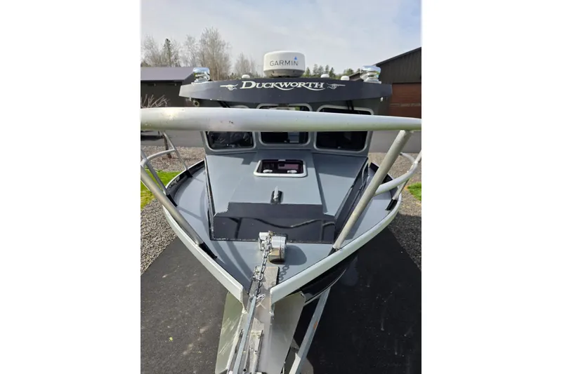 Slide: The Image of 2012 Duckworth 28 Offshore boat with Garmin equipment, docked outdoors. - 32