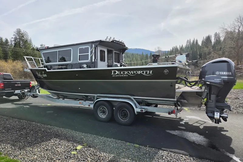 Slide: The Image of 2012 Duckworth 28 Offshore boat on trailer, Yamaha engine, parked outdoors. - 34