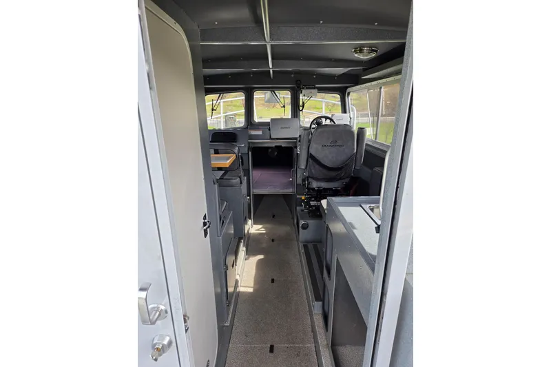 Slide: The Image of Interior view of a 2012 Duckworth 28 Offshore boat, featuring seating and navigation area. - 4