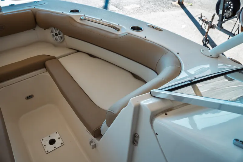 Slide: The Image of Interior seating of a 2019 Key West 239 DFS boat, featuring beige upholstery. - 10