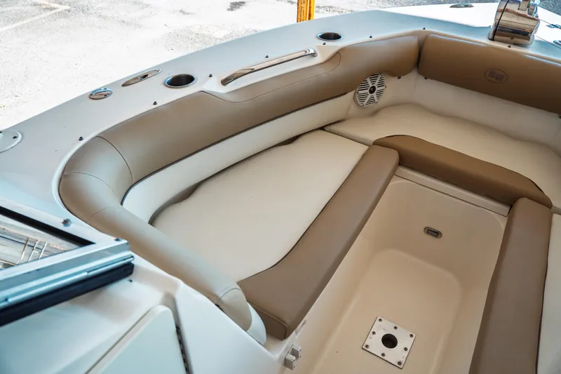 Slide: The Image of 2019 Key West 239 DFS boat interior with cushioned seating and speaker. - 11