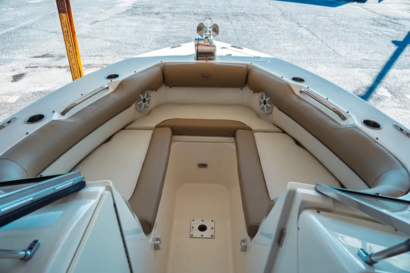 Slide: The Image of 2019 Key West 239 DFS boat interior with cushioned seating and cup holders. - 12