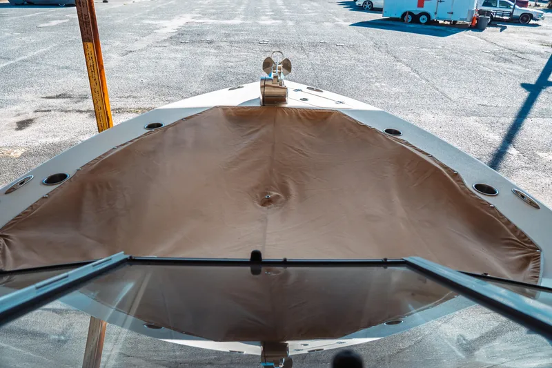 Slide: The Image of 2019 Key West 239 DFS boat with covered bow, parked on asphalt. - 13