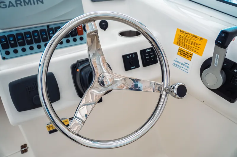 Slide: The Image of Steering wheel of 2019 Key West 239 DFS boat with control panel and throttle. - 17