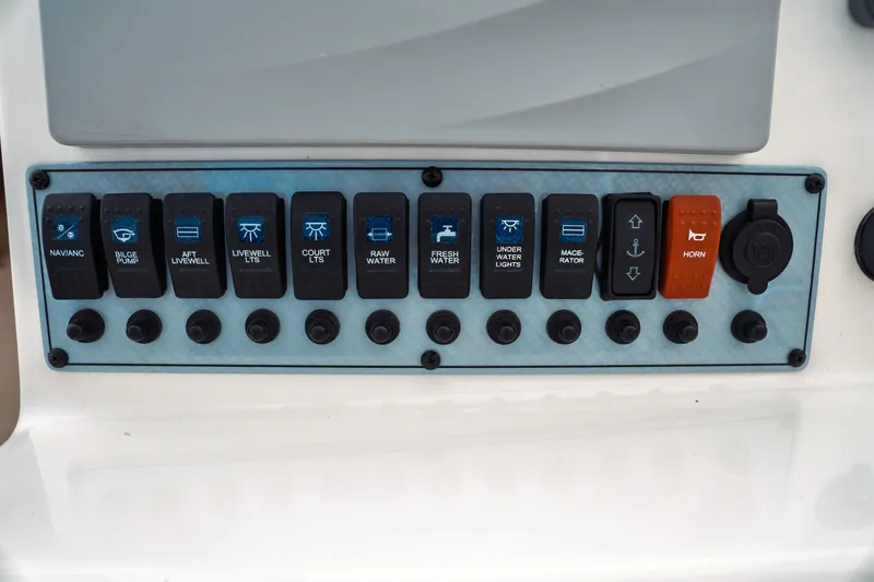 Slide: The Image of Control panel of a 2019 Key West 239 DFS boat with labeled switches. - 19