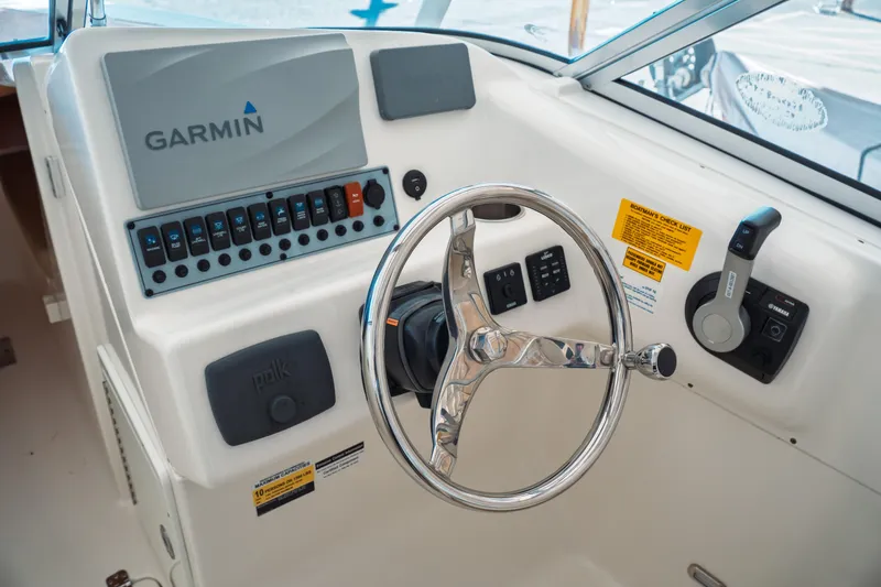 Slide: The Image of 2019 Key West 239 DFS boat dashboard with Garmin navigation and steering wheel. - 20