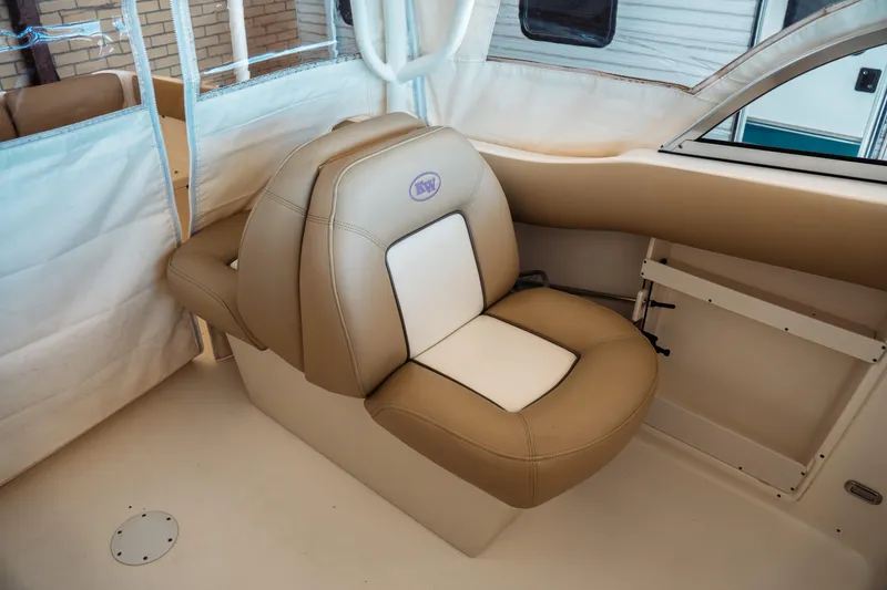 Slide: The Image of 2019 Key West 239 DFS boat interior with tan and white cushioned seating. - 22